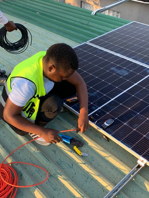 Technician installing solar panels